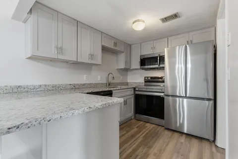 a kitchen with a refrigerator stove and microwave