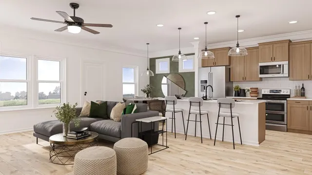 a living room with furniture kitchen area and a wooden floor