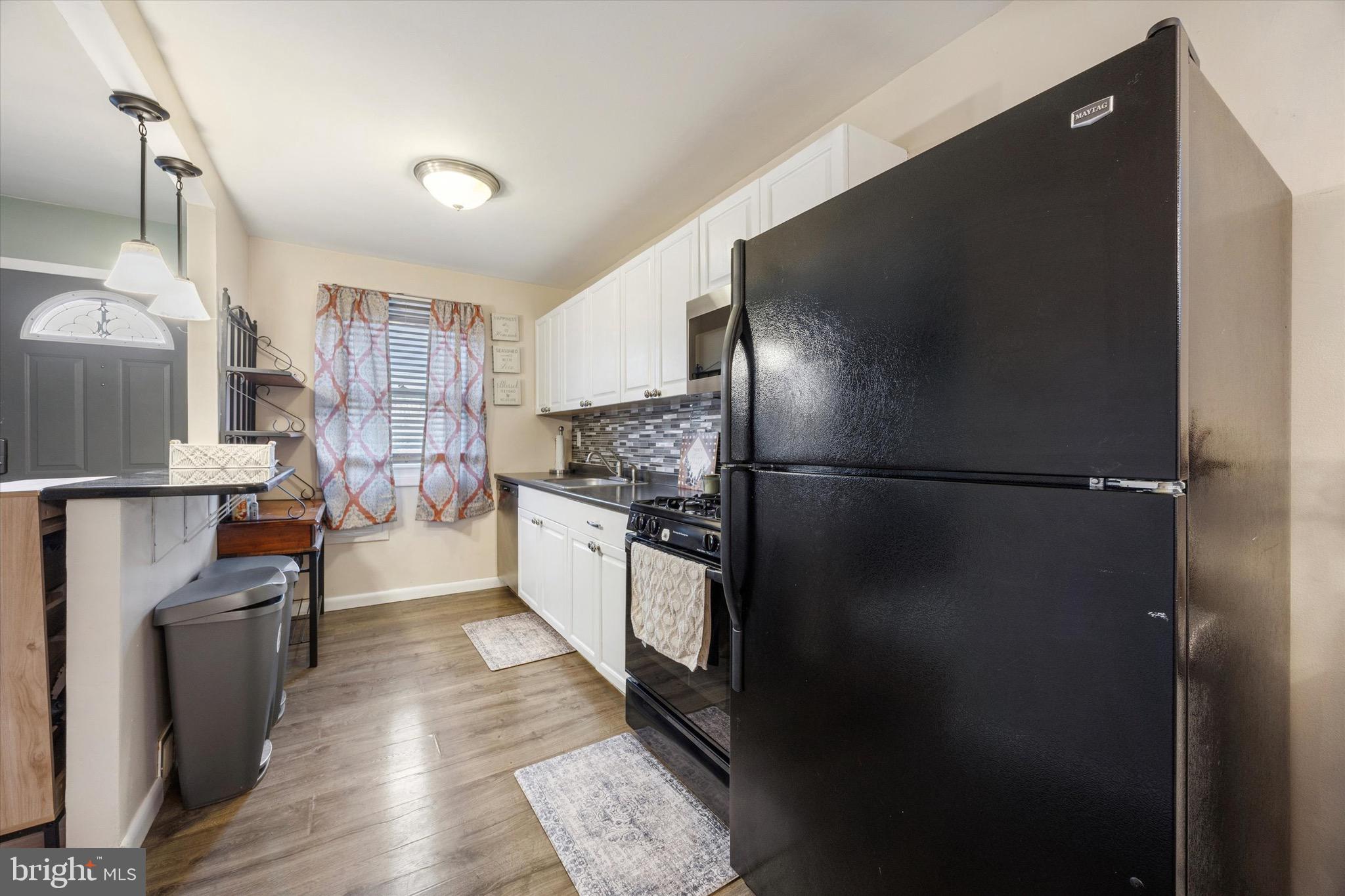 213 Hoffman Road Ridley Park, PA 19078 - Photo 9 of 29 a kitchen with stainless steel appliances a refrigerator and a wooden floors