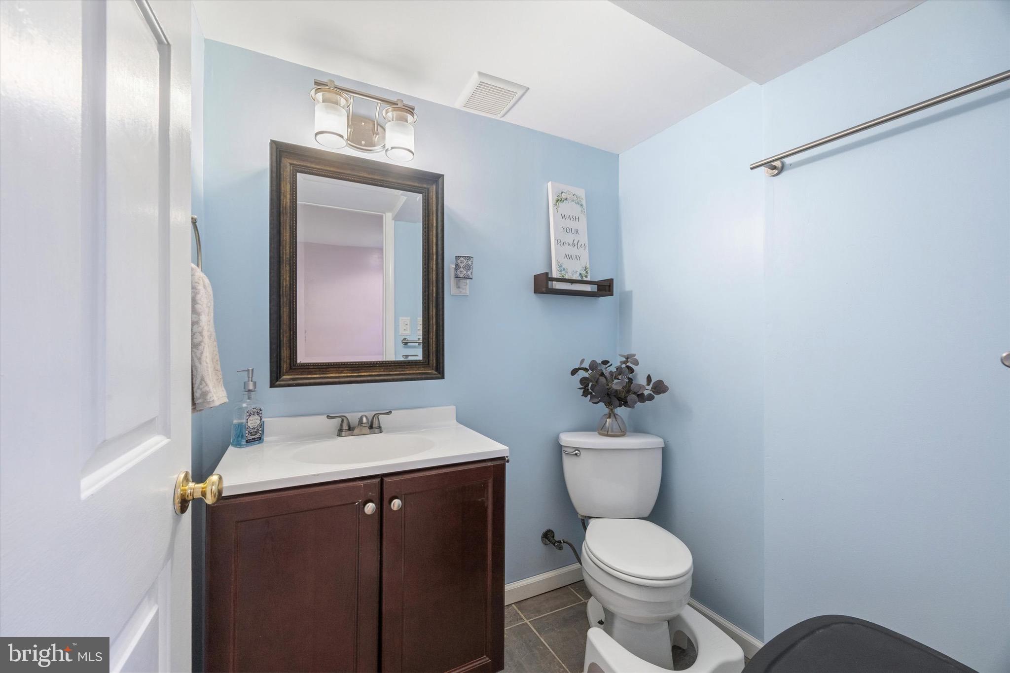 213 Hoffman Road Ridley Park, PA 19078 - Photo 17 of 29 a bathroom with a toilet sink vanity and mirror