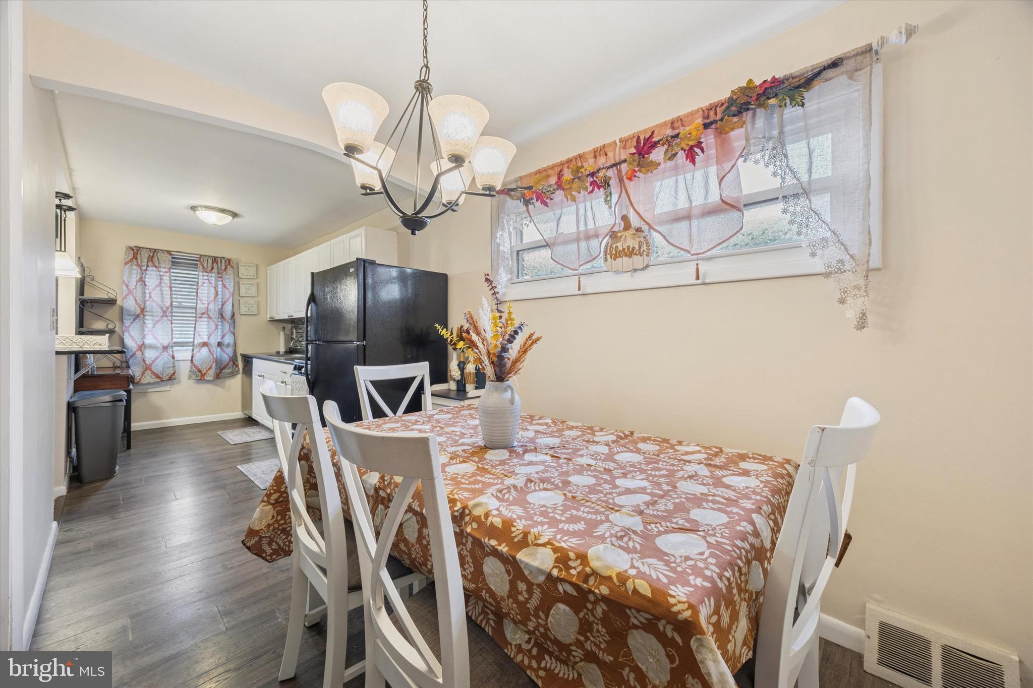 213 Hoffman Road Ridley Park, PA 19078 - Photo 7 of 29 a view of a dining room with furniture a kitchen and chandelier