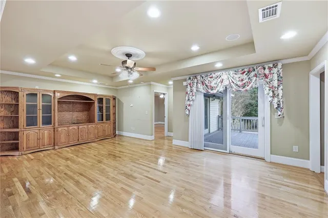 a kitchen with stainless steel appliances granite countertop a refrigerator a stove and a wooden floors