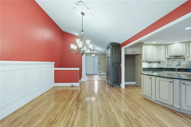 a view of a room with wooden floor and windows