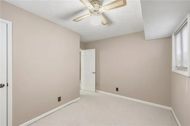 a view of a livingroom with a chandelier fan