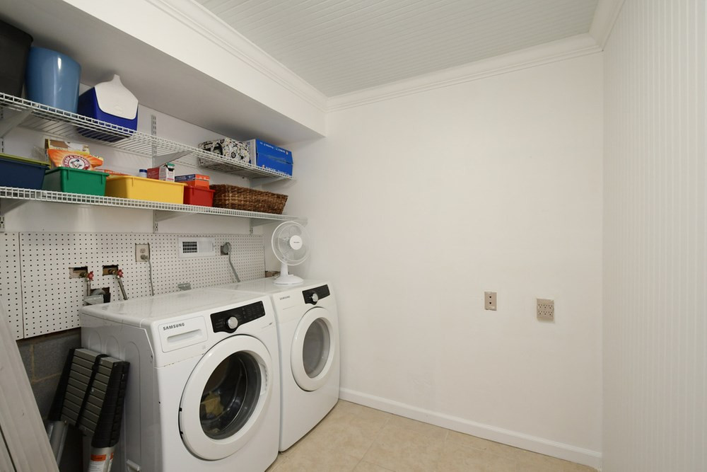 7701 Cresthill Court Raleigh, NC 27615 - Photo 19 of 29 Large Laundry Room with shelving overhead and crown molding. Laundry
