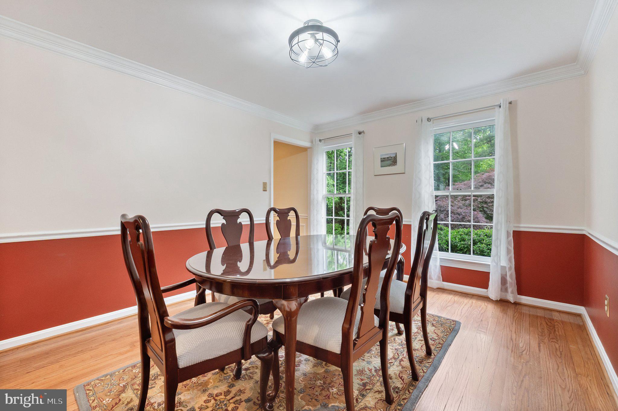 11100 Burywood Lane Reston, VA 20194 - Photo 19 of 42 a dining room with furniture a rug and wooden floor