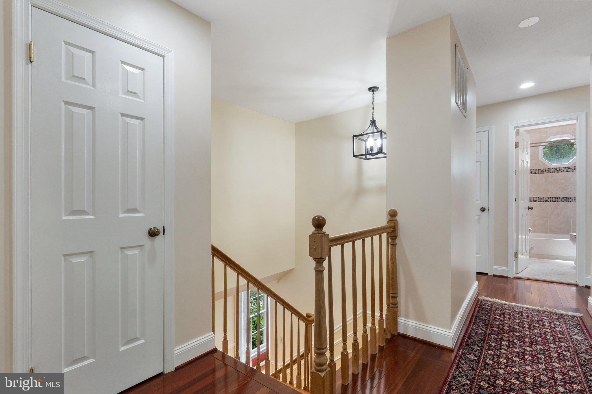 11100 Burywood Lane Reston, VA 20194 - Photo 21 of 42 a view of a hallway with wooden floor and staircase