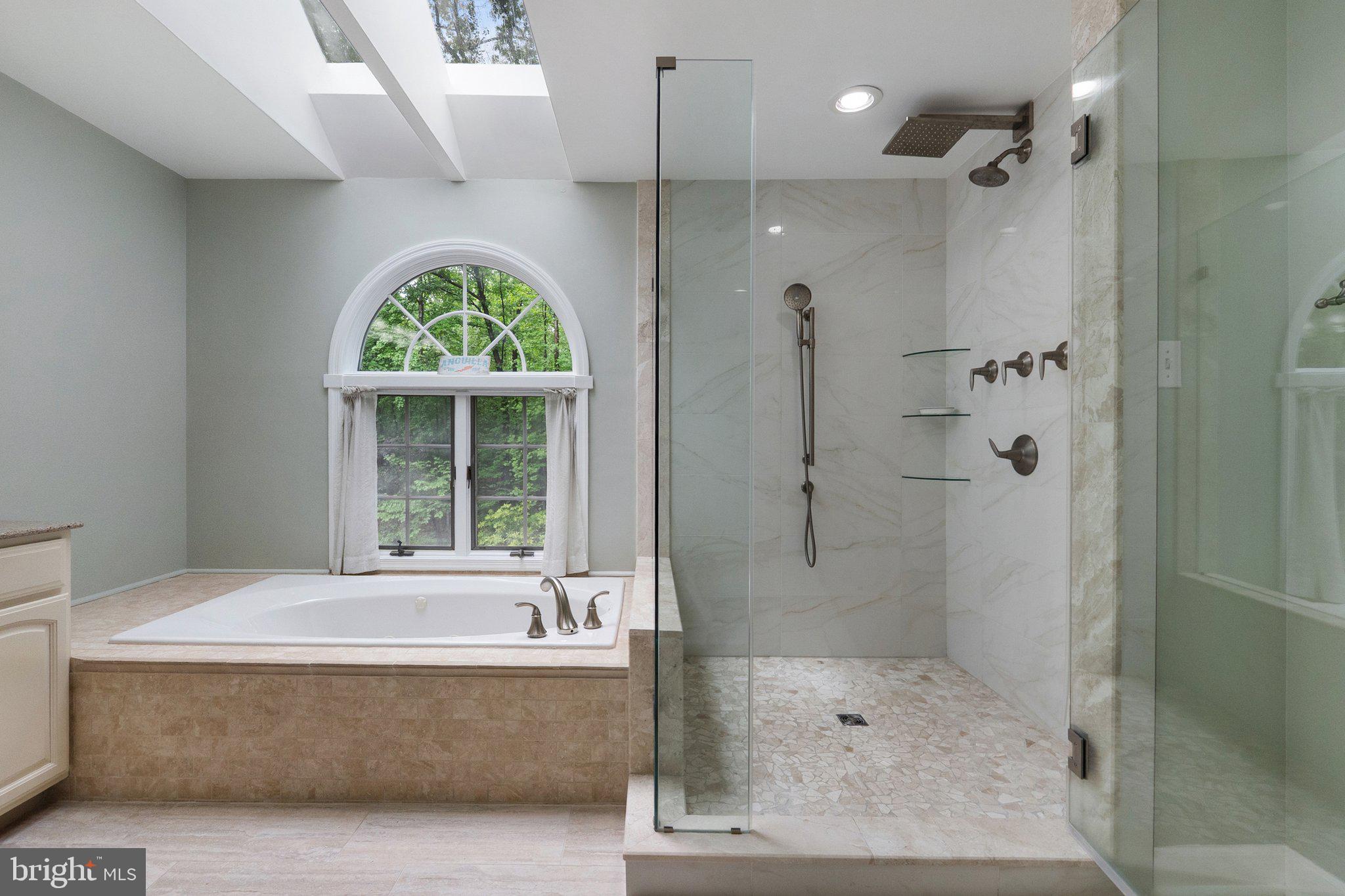 11100 Burywood Lane Reston, VA 20194 - Photo 24 of 42 a bathroom with a tub and a shower