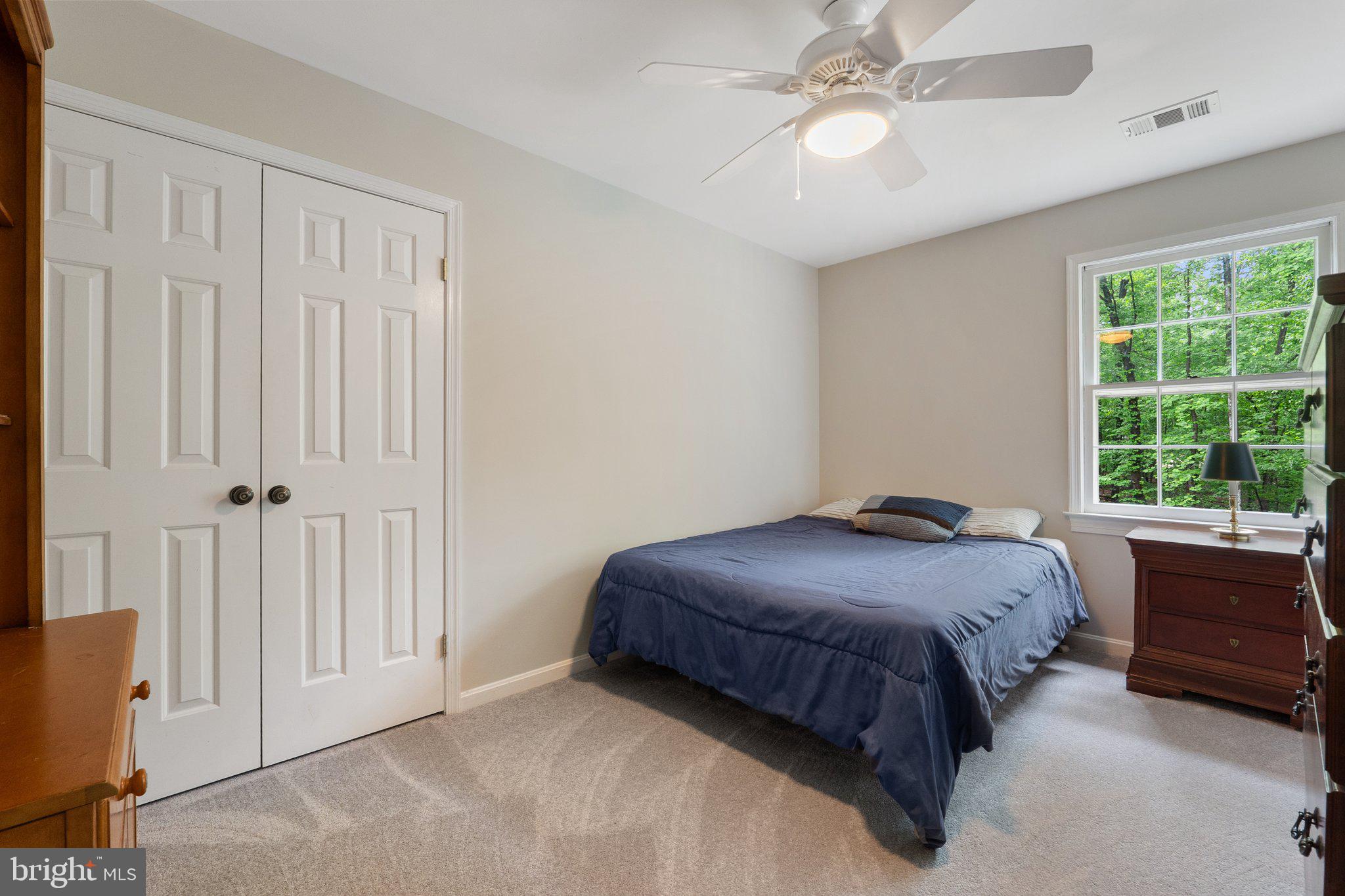 11100 Burywood Lane Reston, VA 20194 - Photo 29 of 42 a bedroom with a bed and a chandelier