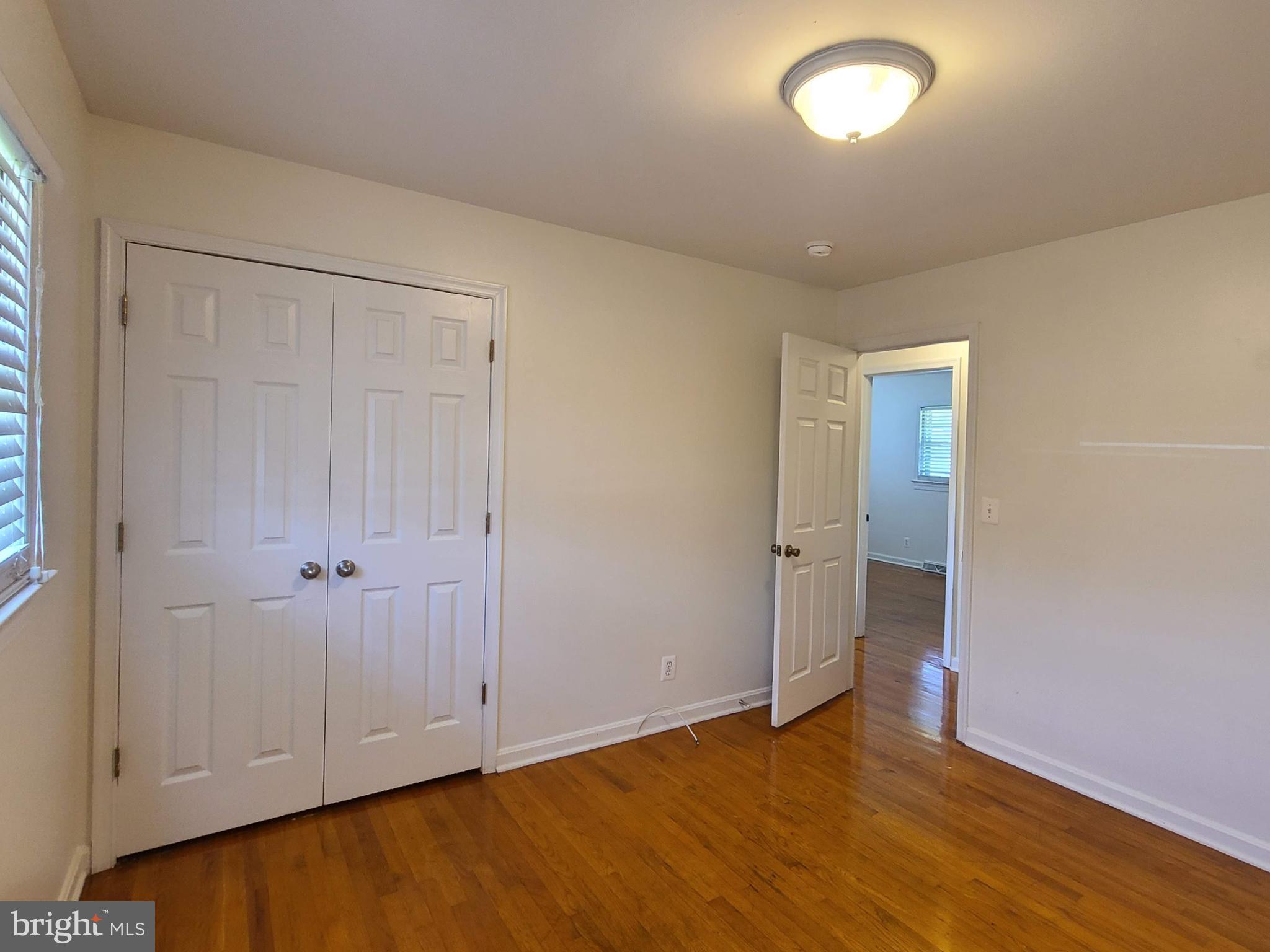 204 Mt Pleasant Boulevard Fredericksburg, VA 22405 - Photo 11 of 30 an empty room with wooden floor and closet area