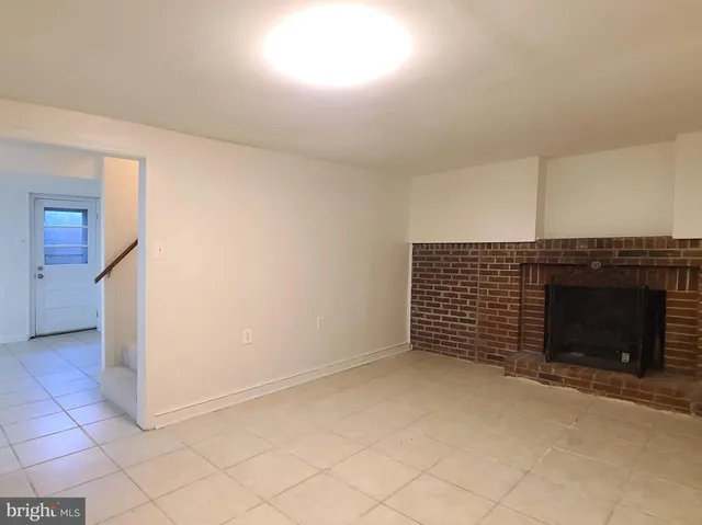 an empty room with a fireplace