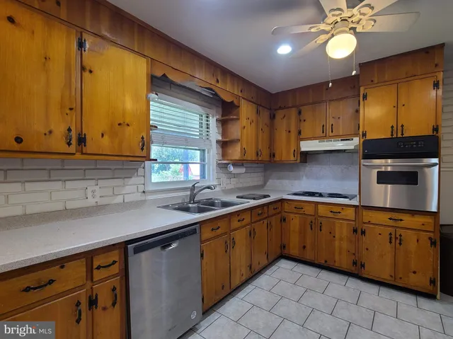 a kitchen with a sink cabinets and window