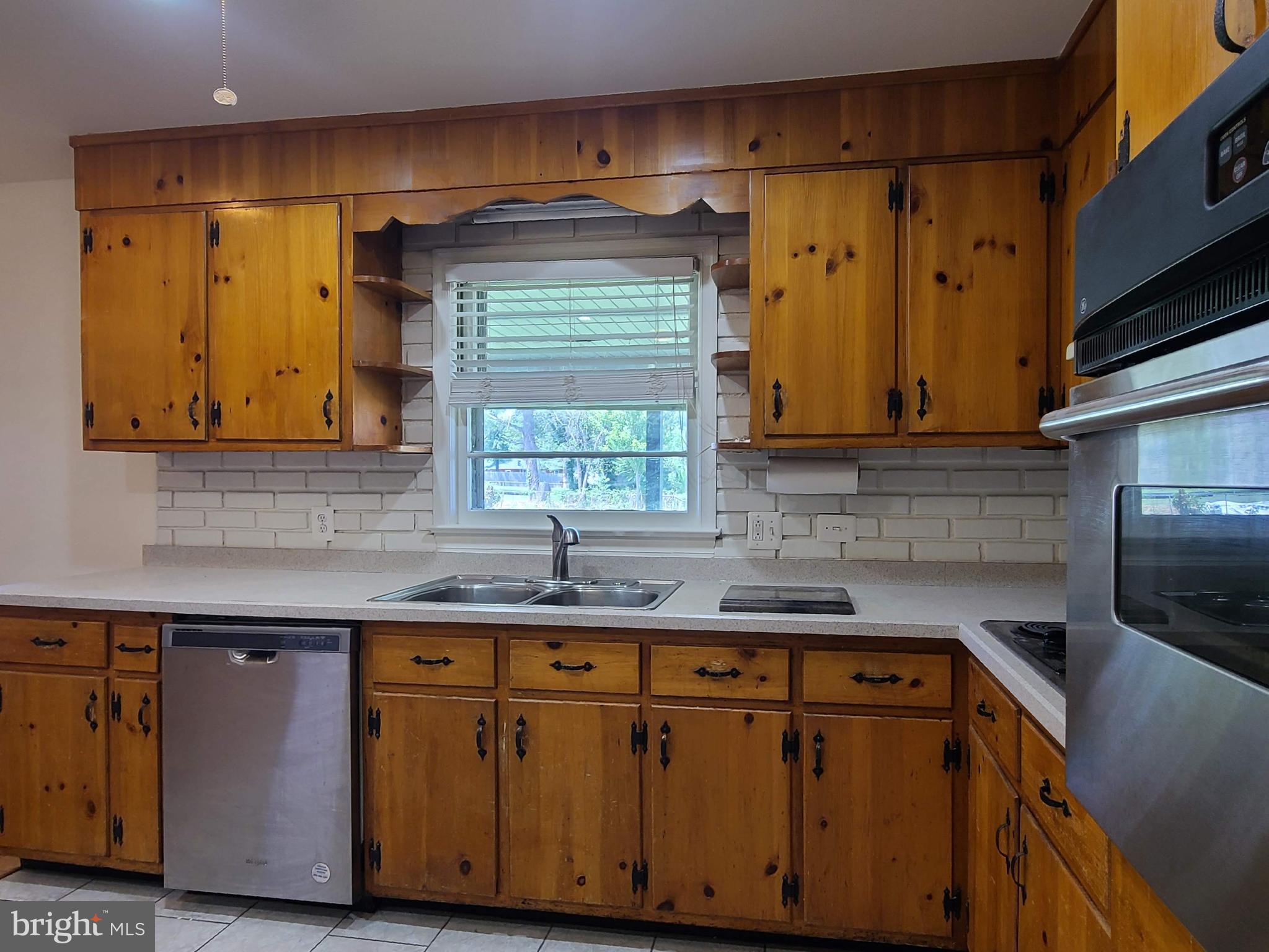 204 Mt Pleasant Boulevard Fredericksburg, VA 22405 - Photo 7 of 30 a kitchen with granite countertop a sink cabinets and stainless steel appliances