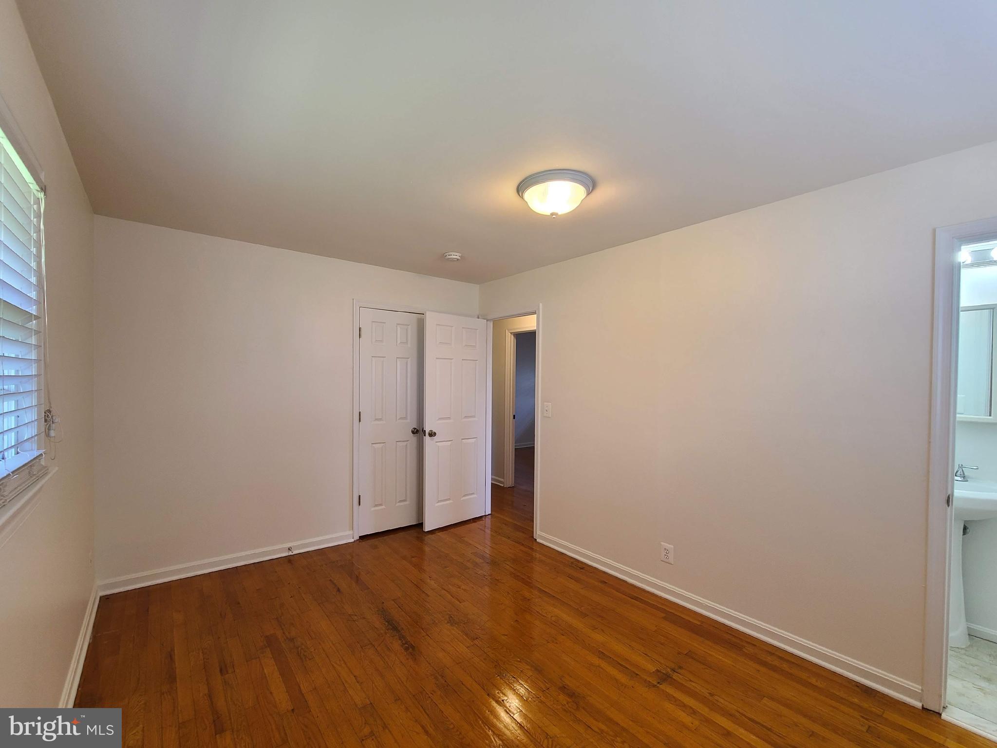 204 Mt Pleasant Boulevard Fredericksburg, VA 22405 - Photo 9 of 30 an empty room with wooden floor and windows