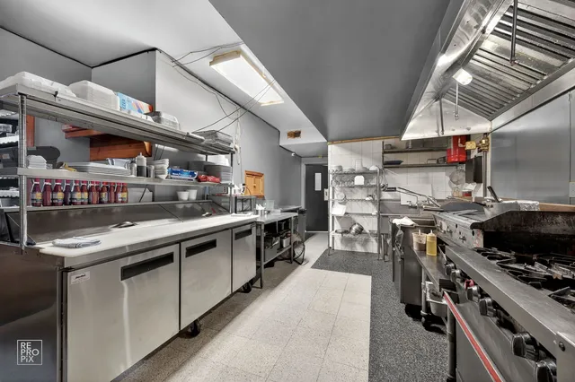 a kitchen with stainless steel appliances granite countertop a stove and a sink