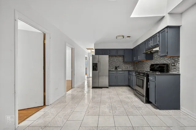 a kitchen with stainless steel appliances granite countertop a refrigerator and a sink