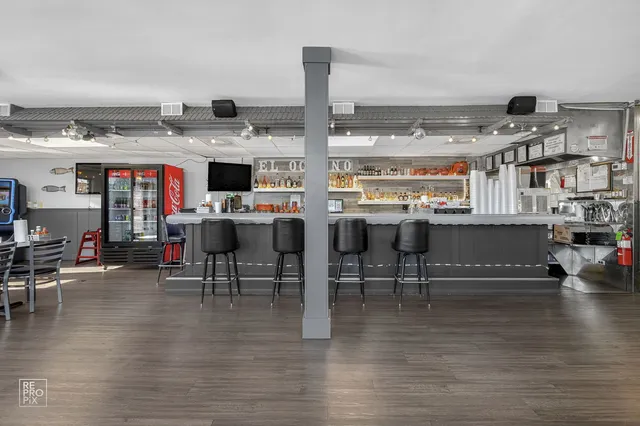 a living room with lots of furniture and kitchen view
