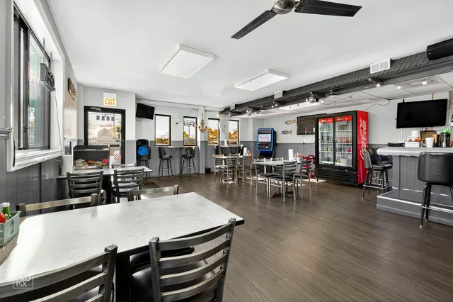a view of a dining room with furniture and wooden floor
