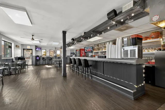 a living room with lots of furniture and wooden floors