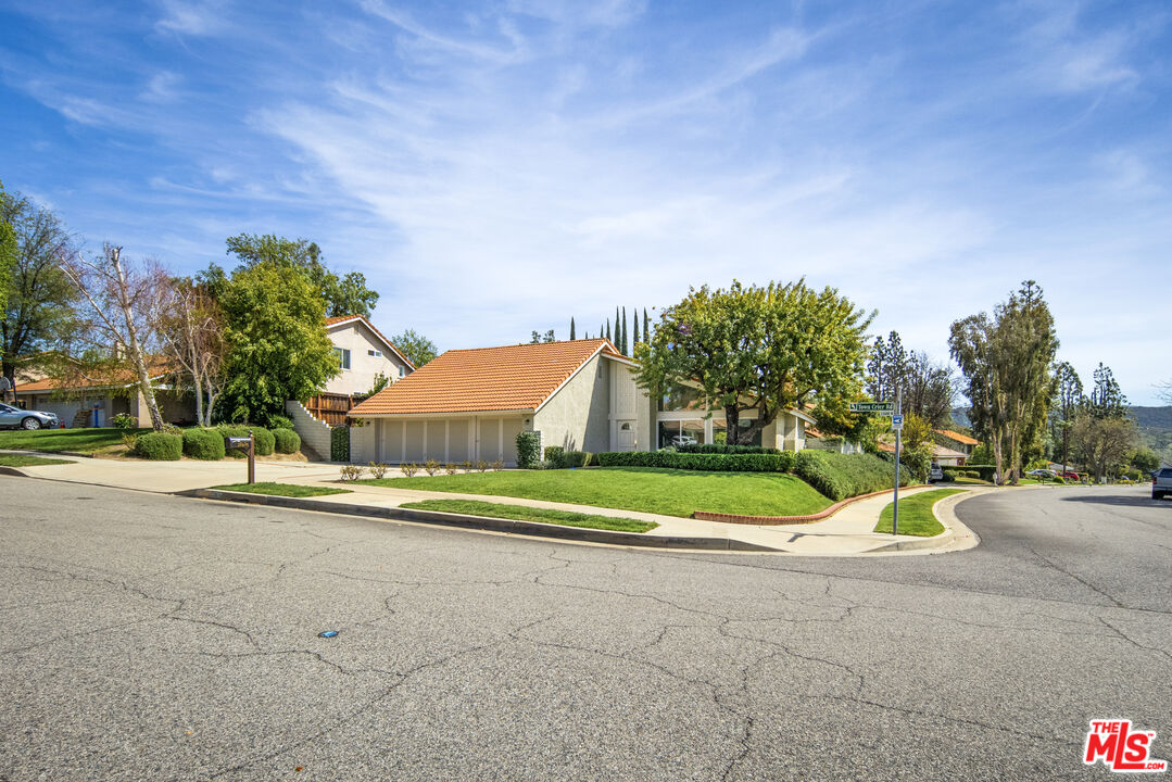 22634 Town Crier Road Calabasas, CA 91302 - Photo 1 of 7 a view of yellow house with a big yard and large trees