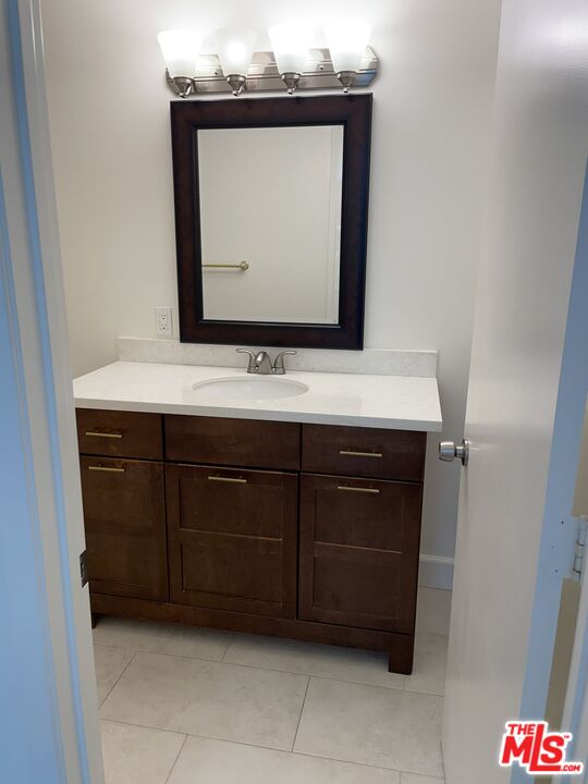 22634 Town Crier Road Calabasas, CA 91302 - Photo 5 of 7 a bathroom with a sink vanity and a mirror
