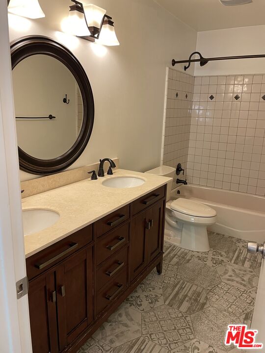 22634 Town Crier Road Calabasas, CA 91302 - Photo 6 of 7 a bathroom with a double vanity sink mirror and toilet