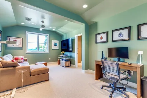a living room with furniture and a book shelf
