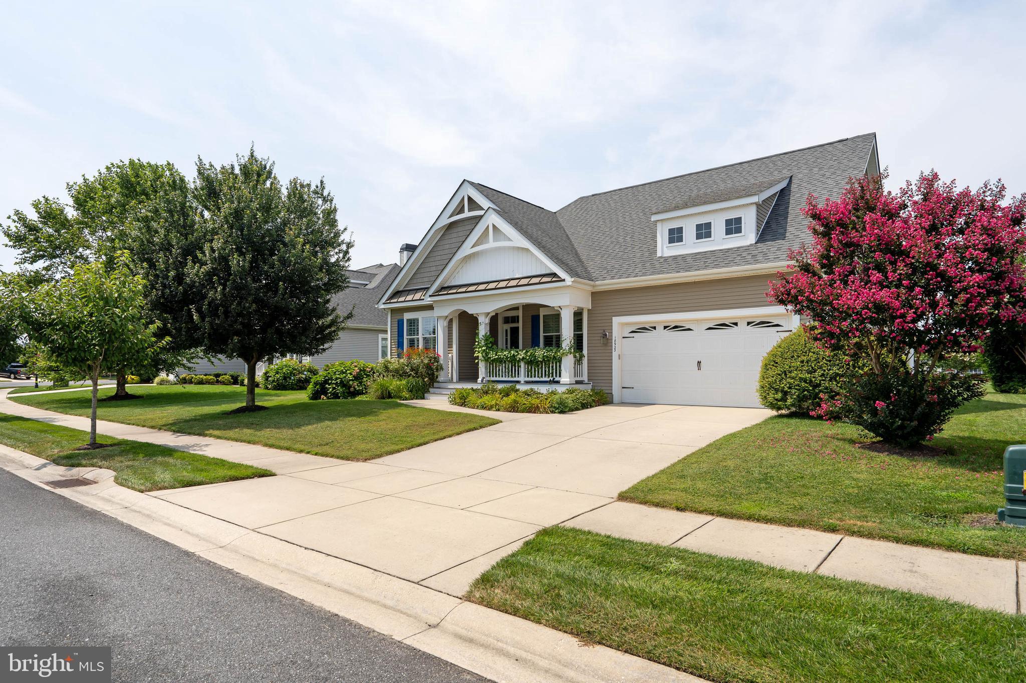 18923 Roth Drive Lewes, DE 19958 - Photo 2 of 73 a front view of a house with a yard and garage