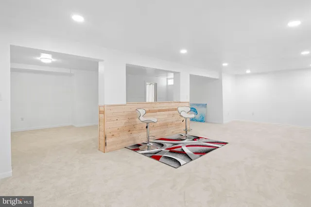 a kitchen with granite countertop white cabinets and stainless steel appliances