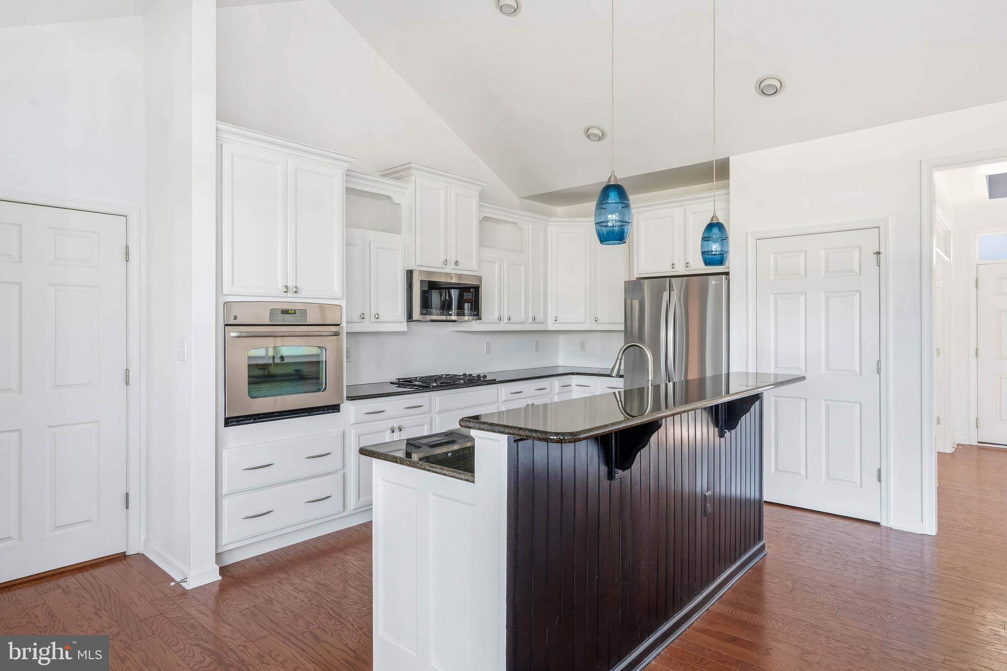 18923 Roth Drive Lewes, DE 19958 - Photo 57 of 73 a kitchen with stainless steel appliances granite countertop a stove a sink and a refrigerator