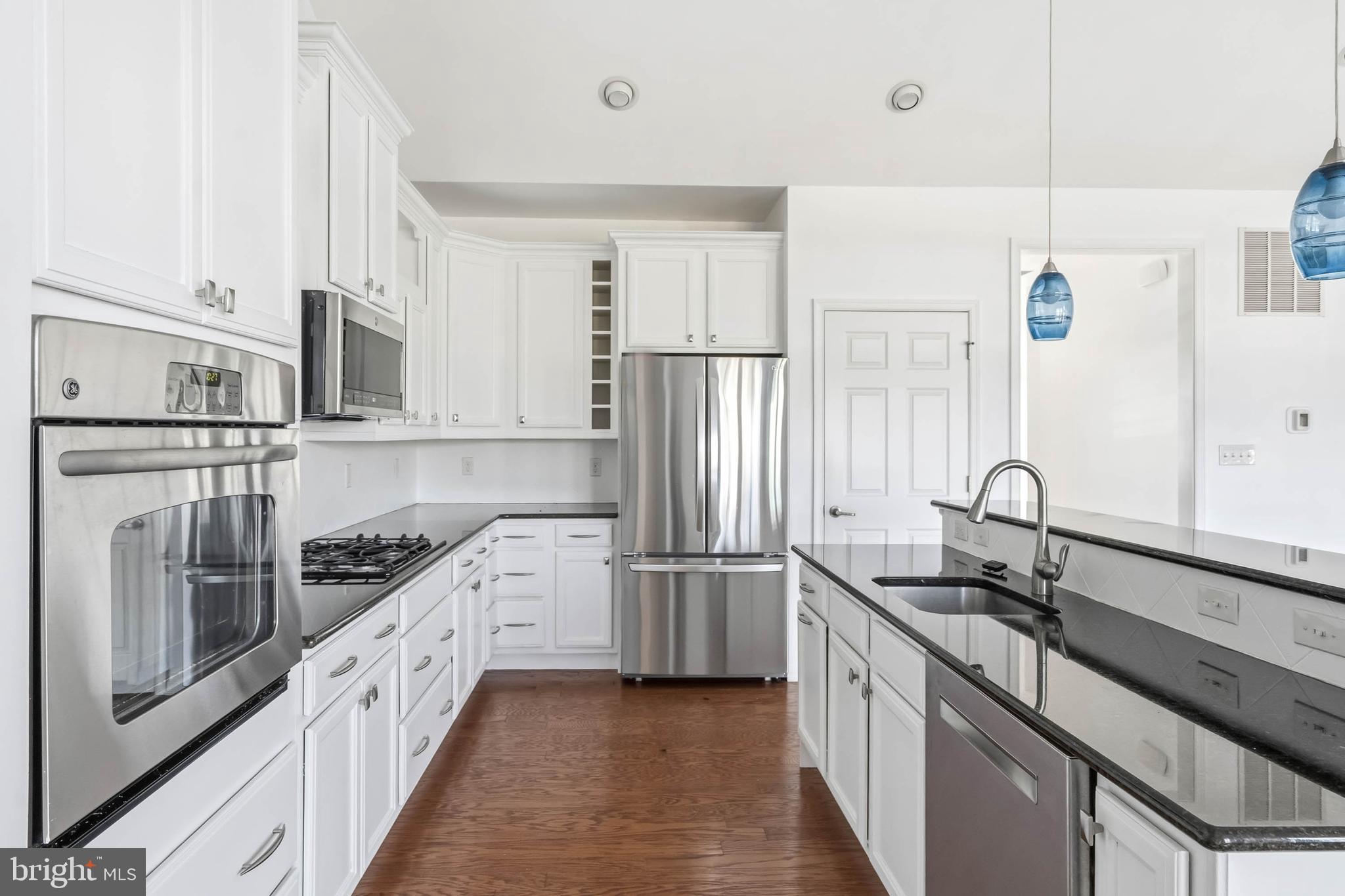 18923 Roth Drive Lewes, DE 19958 - Photo 59 of 73 a kitchen with stainless steel appliances granite countertop a sink stove and refrigerator