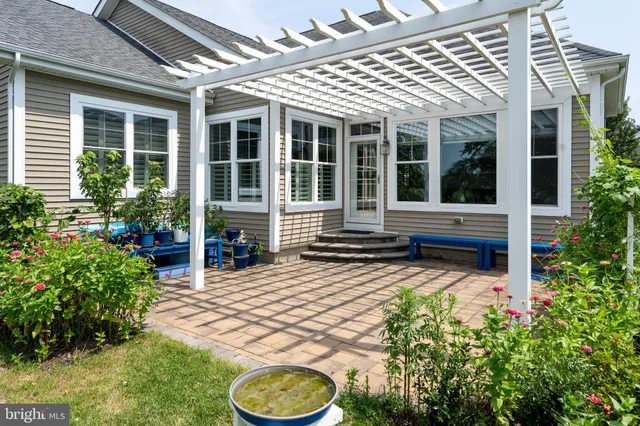 a view of a hallway with wooden floor and a bathroom