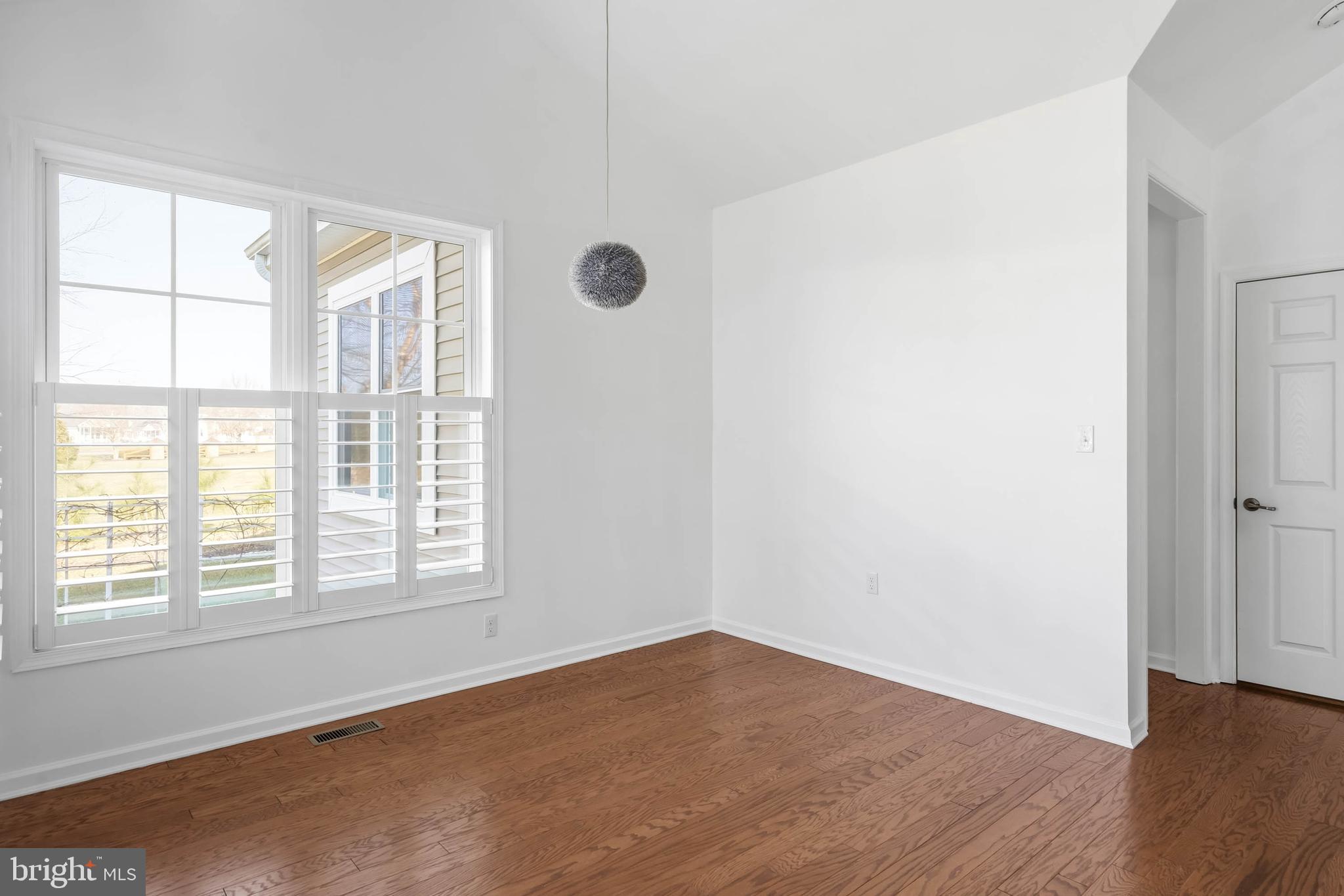 18923 Roth Drive Lewes, DE 19958 - Photo 61 of 73 an empty room with wooden floor and windows