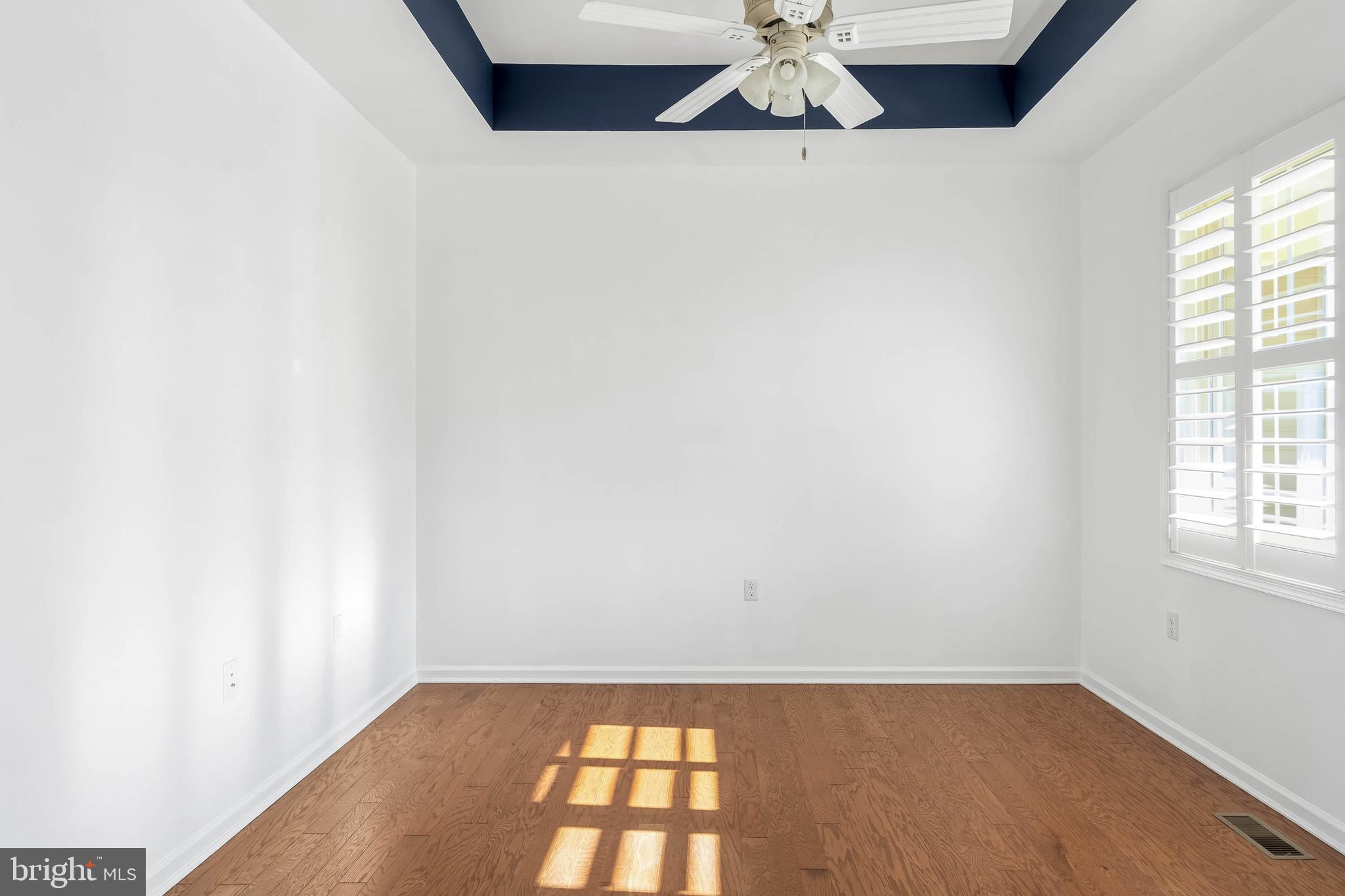 18923 Roth Drive Lewes, DE 19958 - Photo 72 of 73 an empty room with wooden floor and windows