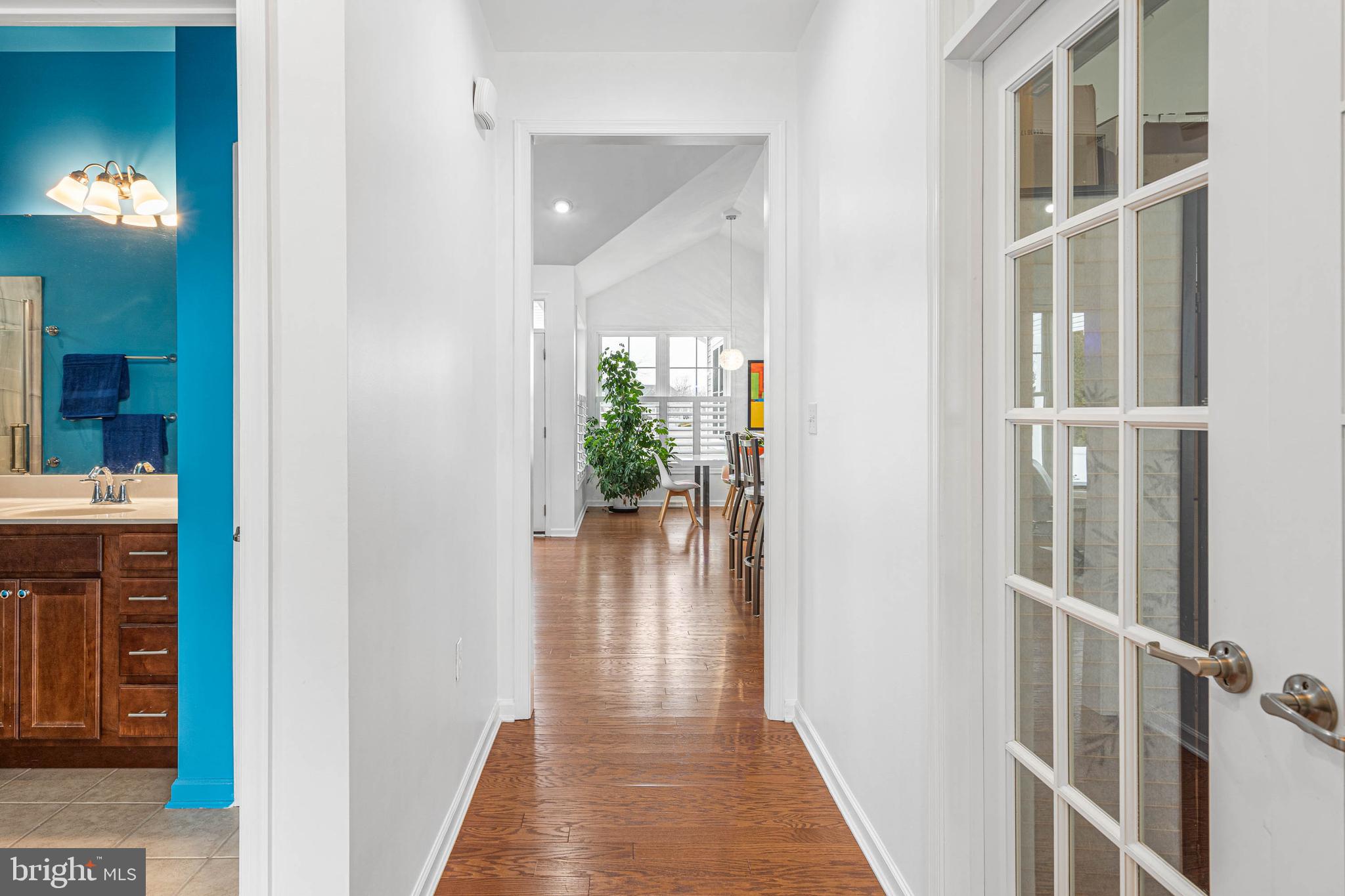 18923 Roth Drive Lewes, DE 19958 - Photo 9 of 73 a view of a hallway with wooden floor and a bathroom
