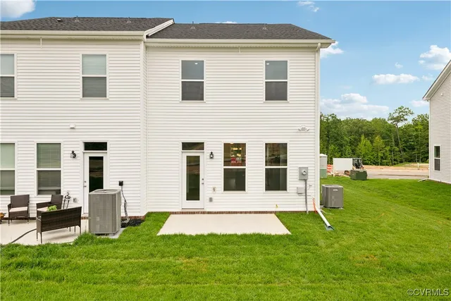 a view of a house with a big yard and large trees