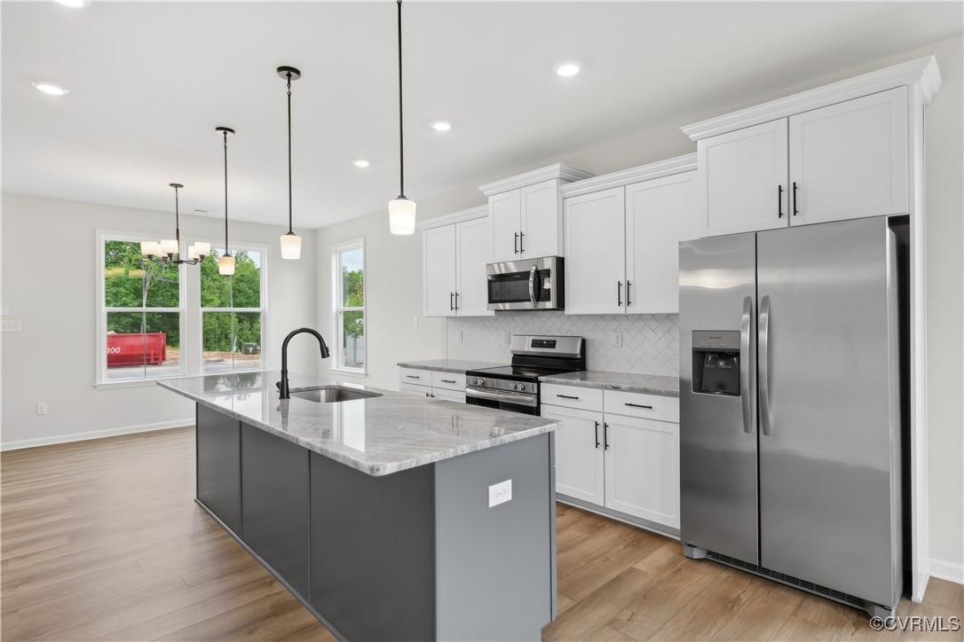331 Mt Mccauley Way Aylett, VA 23009 - Photo 2 of 48 a kitchen with stainless steel appliances granite countertop a sink a stove a refrigerator a center island and a wooden floor
