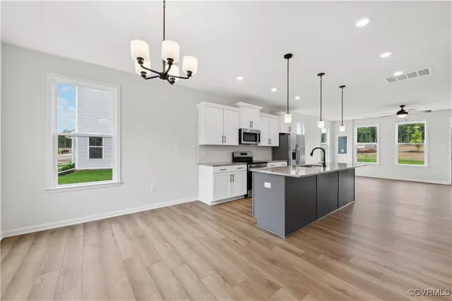 a view of a living room and kitchen with hardwood floor