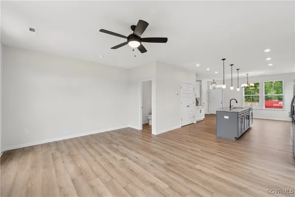 a view of a living room and kitchen with hardwood floor