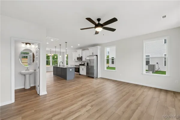 a view of a living room with wooden floor and a window