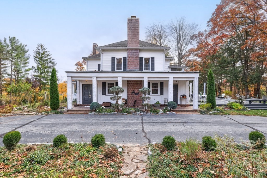 a front view of a house with yard and green space