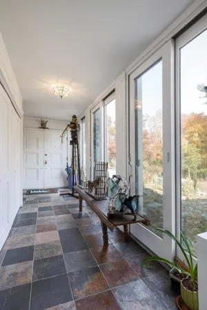 a view of a room with gym equipment and floor to ceiling window