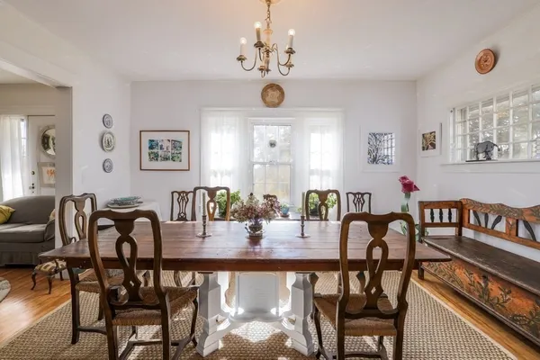 a view of a a dining room with furniture window and wooden floor