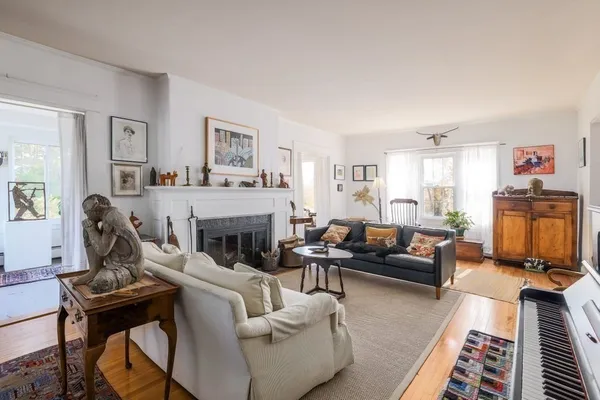 a living room with furniture and a fireplace
