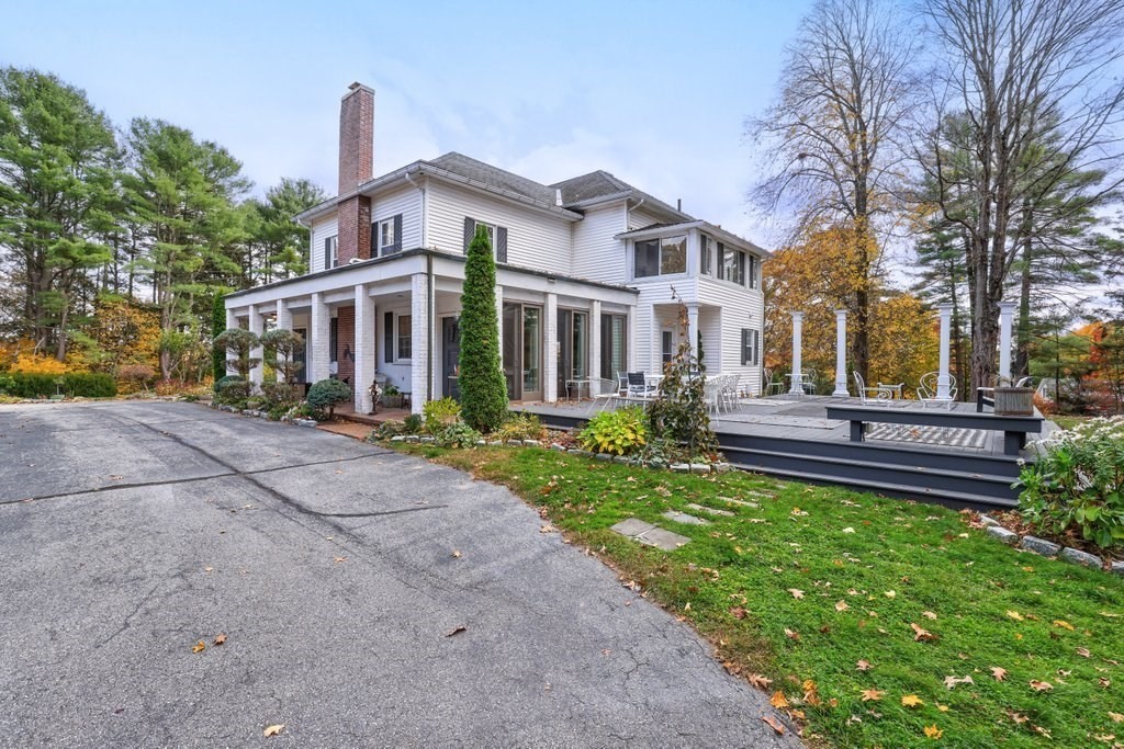 11 Ardlock Place Dudley, MA 01571 - Photo 3 of 42 a front view of a house with a garden and trees