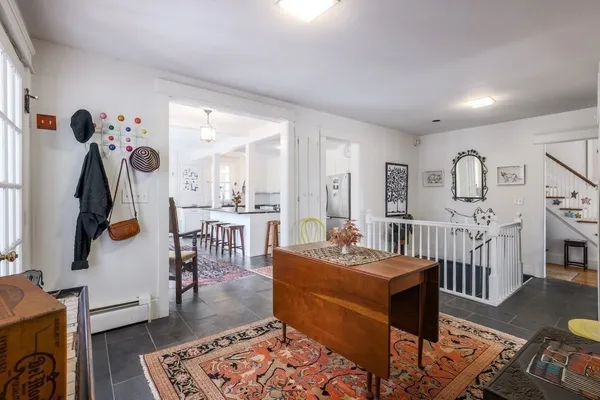 a living room with furniture a rug and a table
