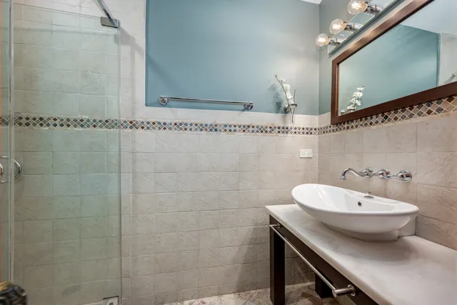 a spacious bathroom with a tub sink and mirror