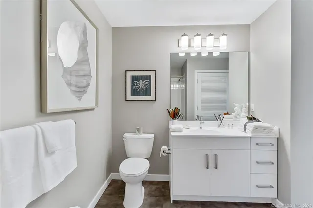 a bathroom with a toilet sink and mirror