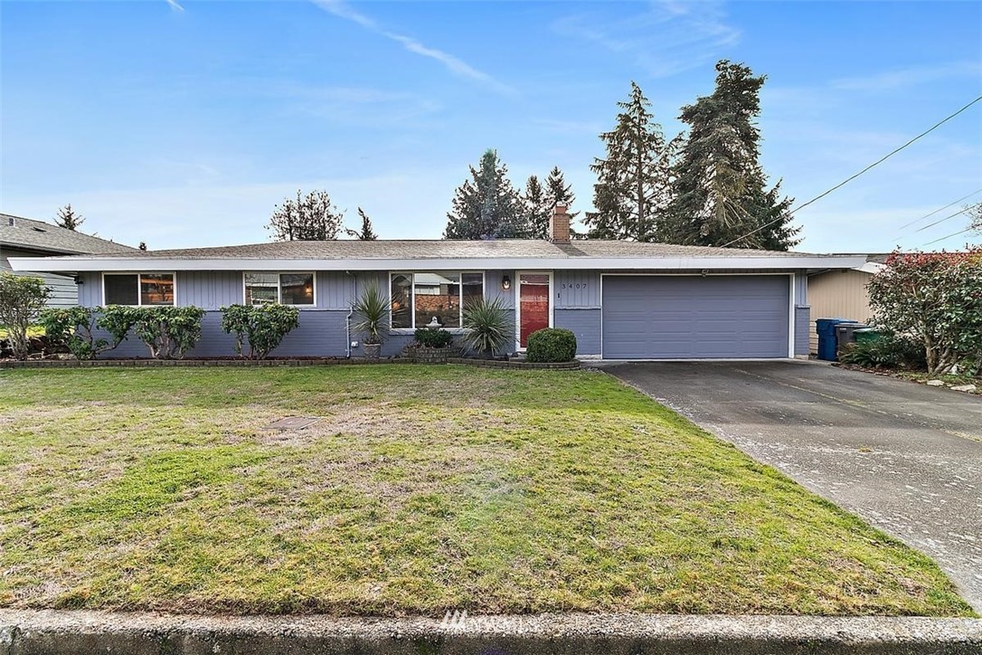 3407 Northeast 11th Street Renton, WA 98056 - Photo 1 of 27 a front view of a house with garden