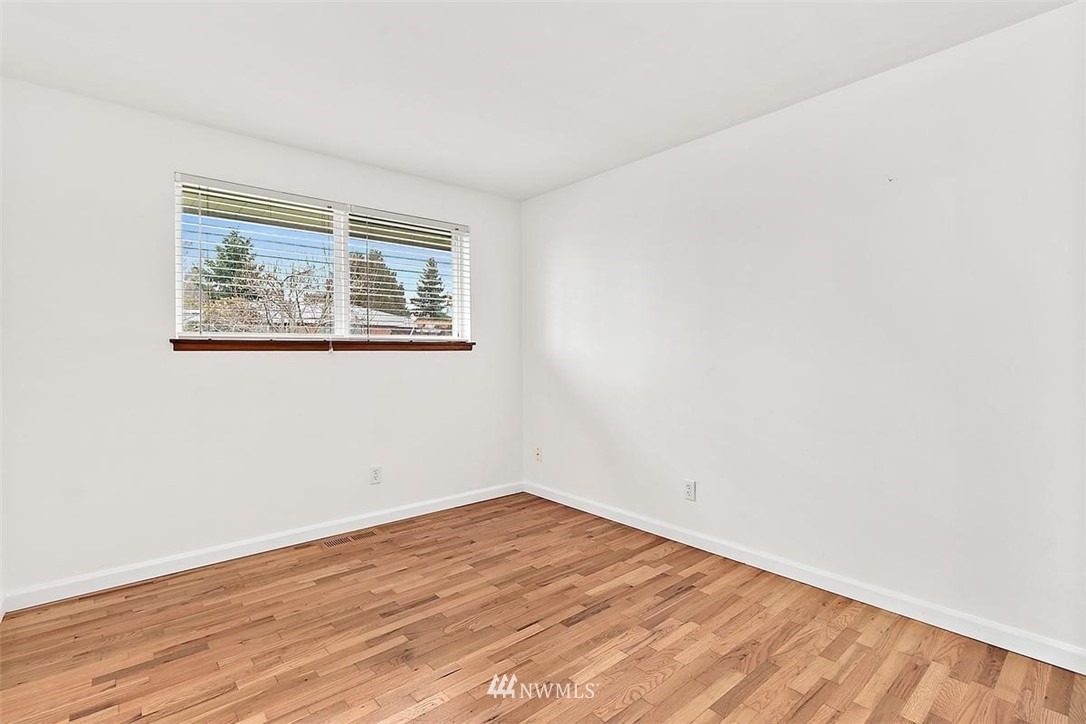 3407 Northeast 11th Street Renton, WA 98056 - Photo 16 of 27 an empty room with wooden floor and windows